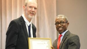 Prof Crick Lund receiving his award